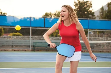 Bridget outside playing pickleball